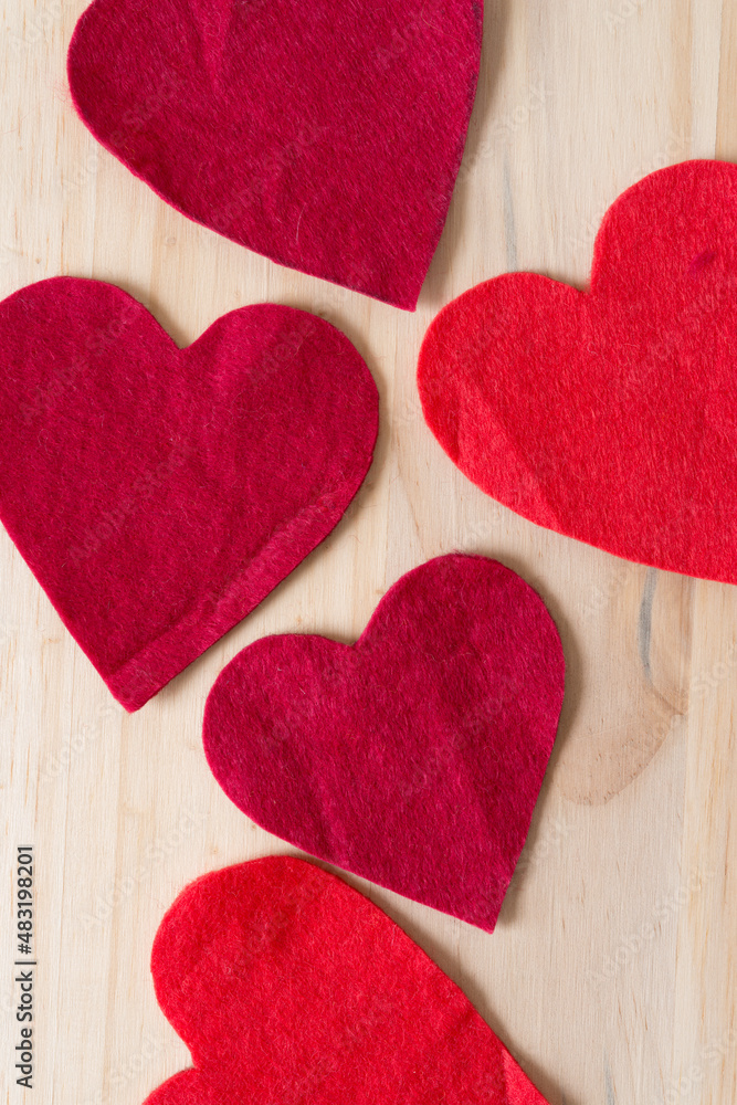 Obraz premium several felt hearts on a wooden surface