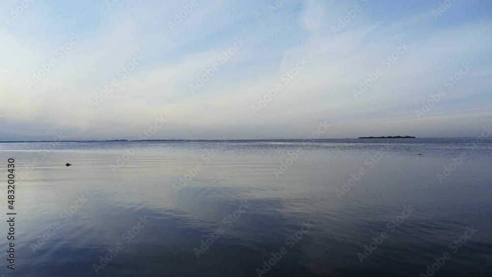 seascape, blue sky and clouds are reflected in the smooth surface of the sea seascape, blue sky and clouds are reflected in the smooth surface of the sea
