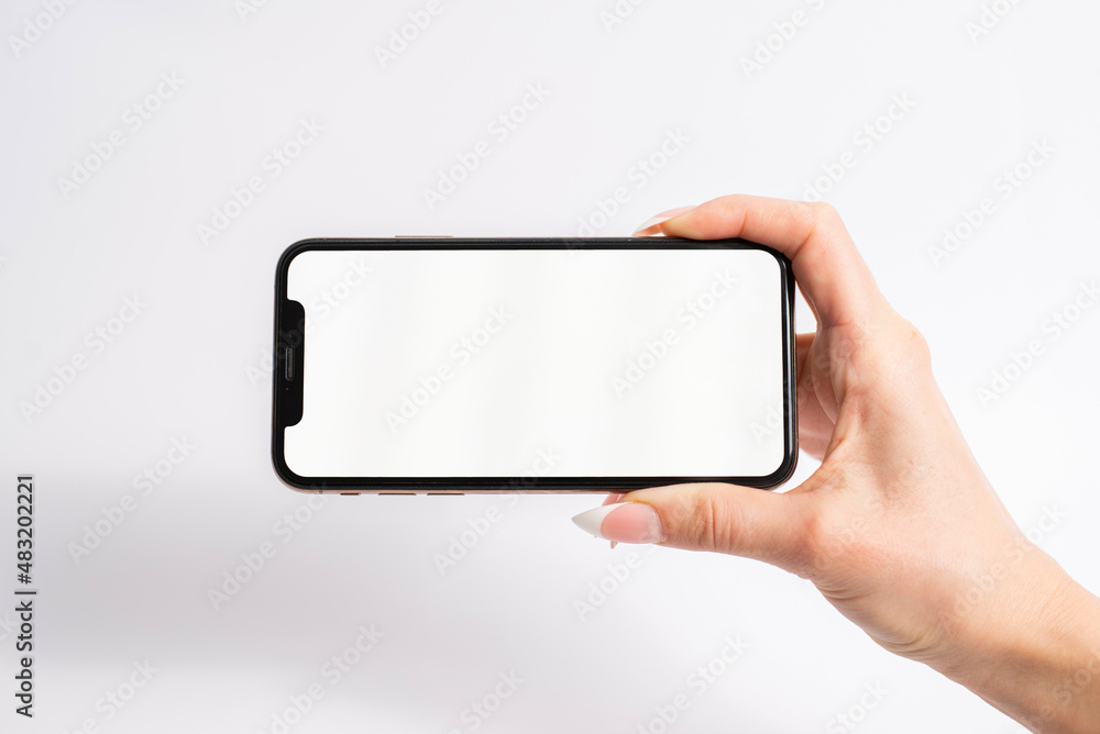 Mobile phone with blank white screen held in one hand on white background Mobile phone with blank white screen held in one hand on white background
