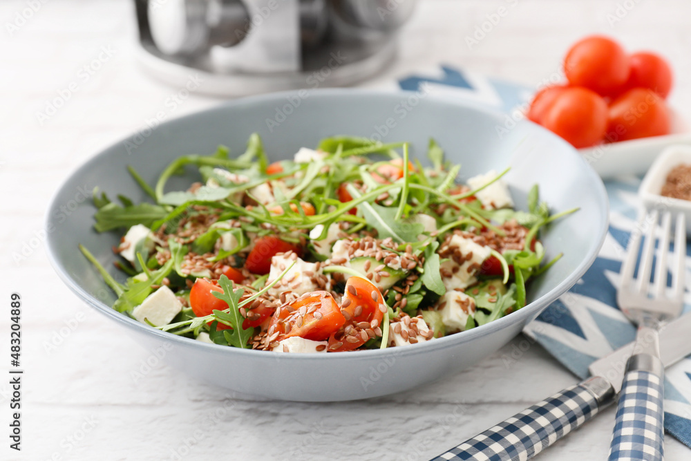Bowl with tasty healthy vegetable salad on table