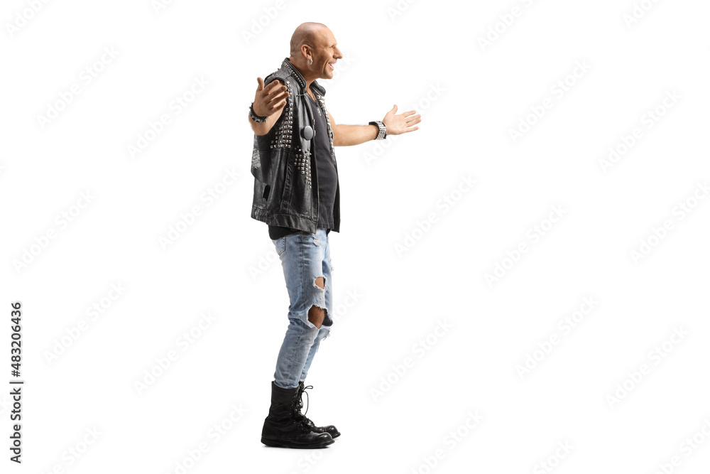 Full length profile shot of a punk standing with arms wide open Full length profile shot of a punk standing with arms wide open