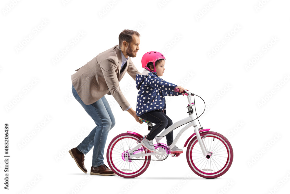 Father holding a little girl trying to ride a bicycle