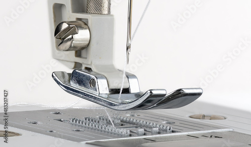 Needle plate, foot and transporter of a sewing machine