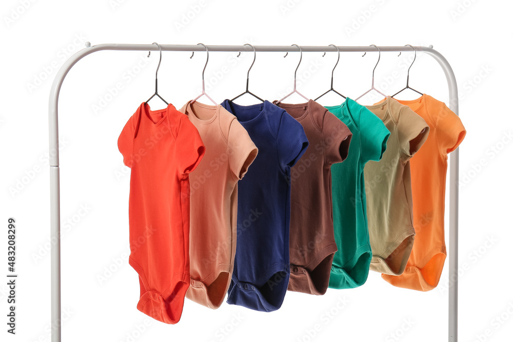 Obraz premium Rack with different baby bodysuits on white background
