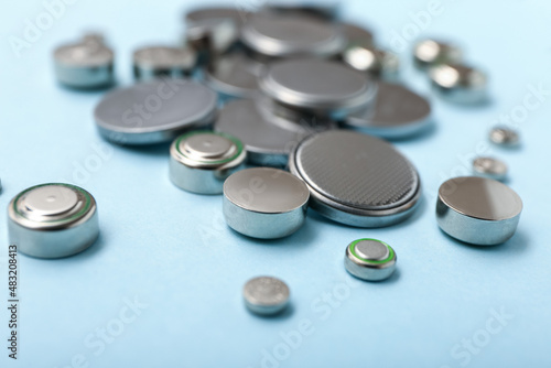 Fotografía Lithium button cell batteries on blue background, closeup
