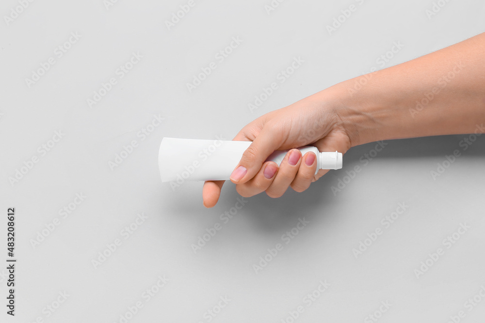 Female hand with tooth paste on white background Female hand with tooth paste on white background