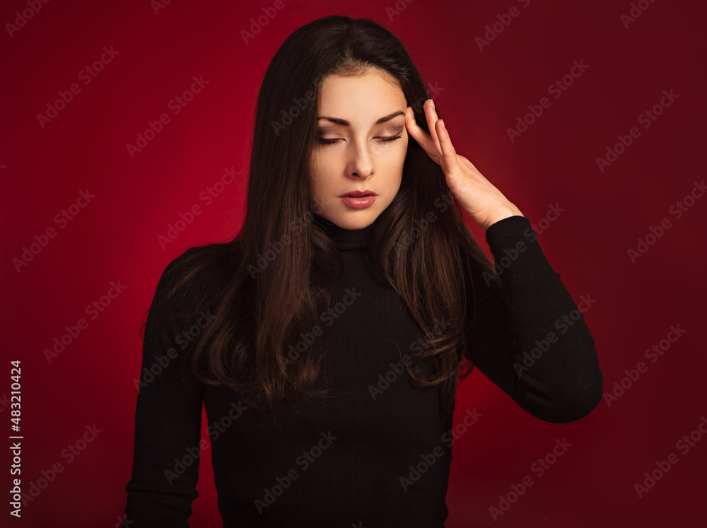 Business concentrate thinking woman find the answer in clever mind with closed eyes with fingers near the face in black sweater on dark shadow red background. Closeup front Business concentrate thinking woman find the answer in clever mind with closed eyes with fingers near the face in black sweater on dark shadow red background. Closeup front