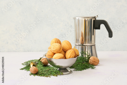 Canvastavla Bowl of tasty walnut shaped cookies with boiled condensed milk, coffee maker and