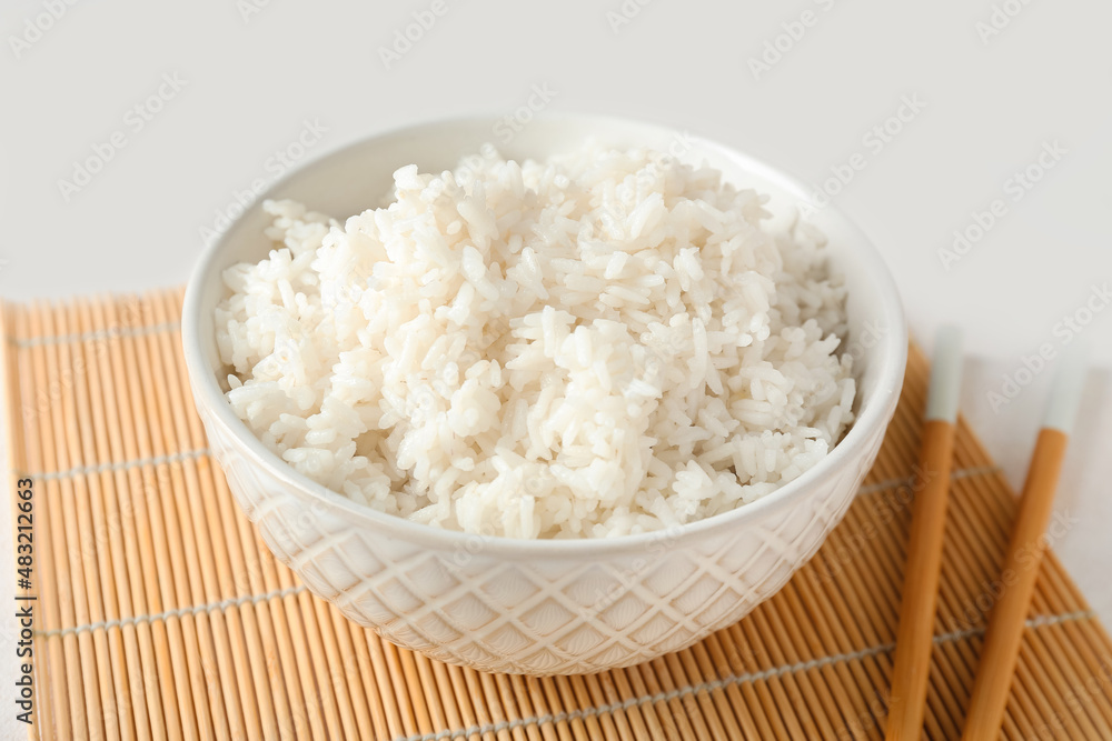 Bowl with tasty boiled rice on light background, closeup Bowl with tasty boiled rice on light background, closeup