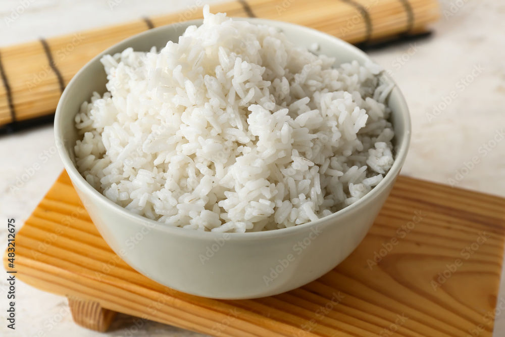 Bowl with tasty boiled rice on light background, closeup Bowl with tasty boiled rice on light background, closeup