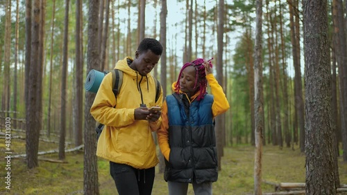 Wallpaper Mural Hikers walking in forest. Couple of black men and women walk in the woods during a trip to the woods with backpacks in slow motion. Torontodigital.ca