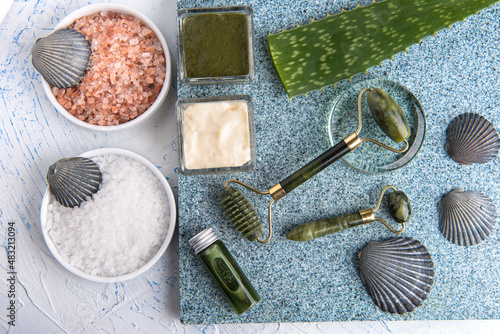 Cosmetic procedures for skin care. Jade roller and aloe vera. Sea salt baths and lotions. View from above.