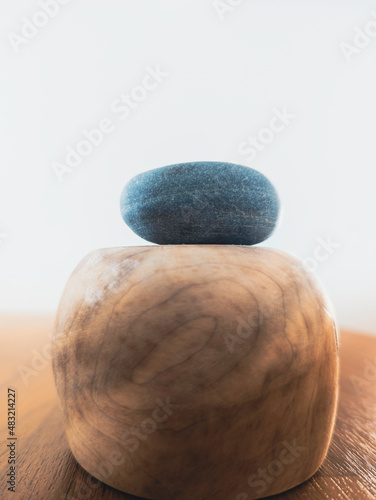 Canvas Print Abstract background image of a blue zen rock on the round wooden pedestal on lig