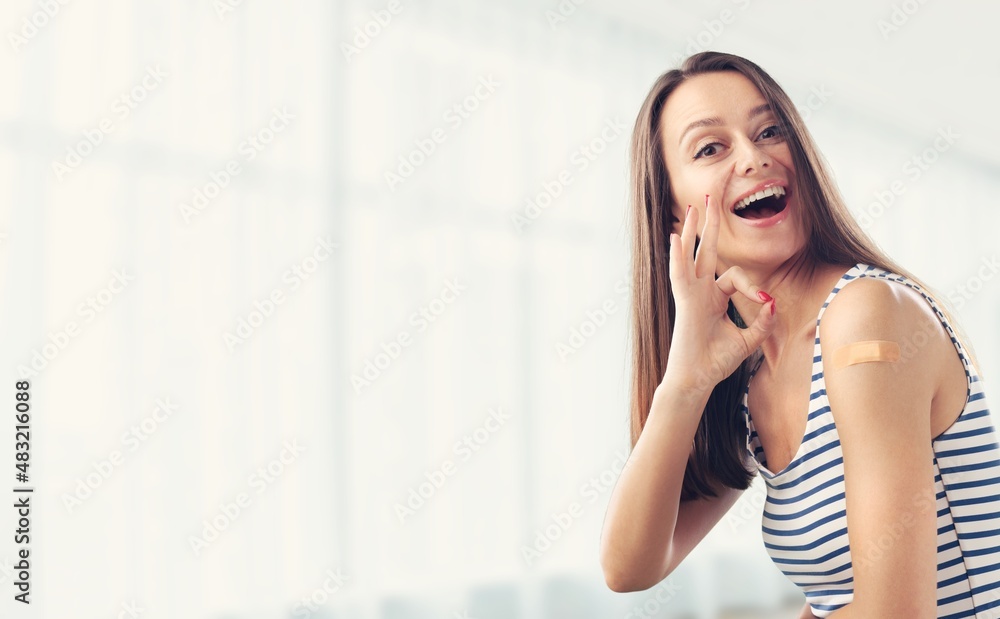 Concept of covid-19 vaccine. Happy lady showing vaccinated arm after antiviral injection Concept of covid-19 vaccine. Happy lady showing vaccinated arm after antiviral injection