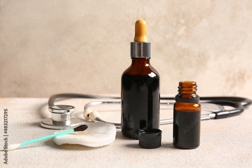 Bottles with iodine, cotton pad, swab and stethoscope on grunge background, closeup Bottles with iodine, cotton pad, swab and stethoscope on grunge background, closeup