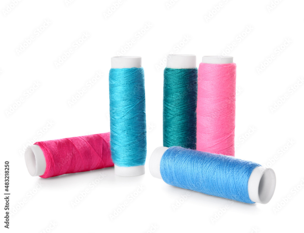 Different sewing thread spools on white background Different sewing thread spools on white background