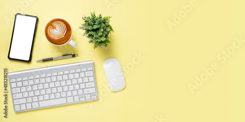 Office desk with computer, Blank screen smart phone, mouse, pen, Cup of coffee on pink background, Top view with copy space, Mock up.