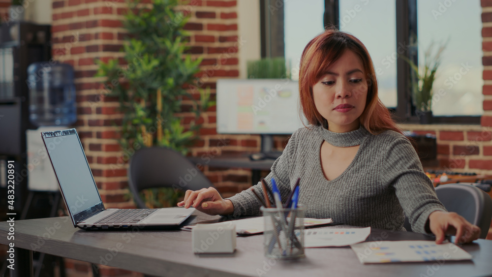 Business woman analyzing sales statistics on papers in startup office, planning investment strategy for company growth. Financial consultant working on e commerce development with analysis. Business woman analyzing sales statistics on papers in startup office, planning investment strategy for company growth. Financial consultant working on e commerce development with analysis.