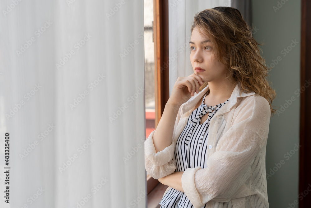 Close up portrait of young woman thinking about problems and looking away by putting hand on her chin Close up portrait of young woman thinking about problems and looking away by putting hand on her chin