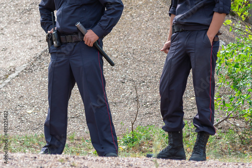 Police officers with a baton, protection of the territory.