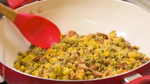 Northeastern Feijao Tropeiro, brazilian dish made with cuscuz, string bean, sausage, bacon, chive and curd cheese. 