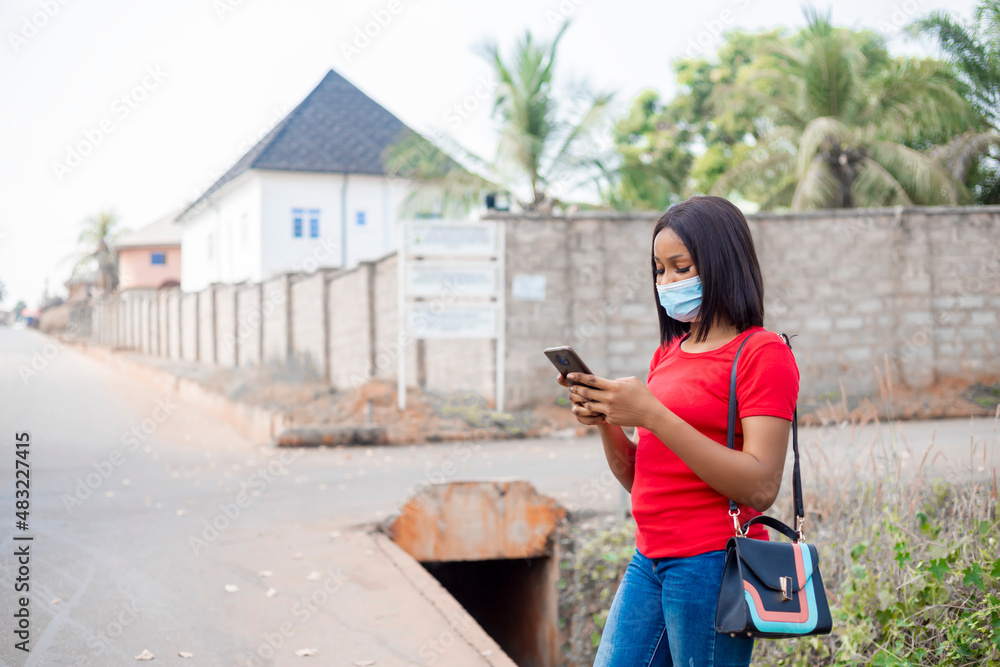 young black african woman using smartphone outdoor ordering taxi booking, online shopping ,mobile, banking using smartphone young black african woman using smartphone outdoor ordering taxi booking, online shopping ,mobile, banking using smartphone