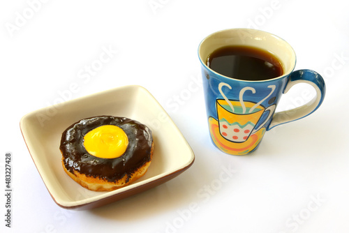 chocolate donut with colorful cup of coffee photo