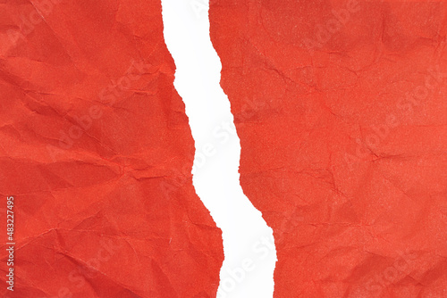 Crumpled red paper torn vertically with torn edges on a white background. isolated. place for your text.