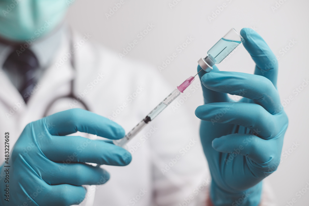doctor or scientist in the COVID-19 medical vaccine research and development laboratory holds a syringe with a liquid vaccine to study and analyze antibody samples for the patient.
doctor or scientist in the COVID-19 medical vaccine research and development laboratory holds a syringe with a liquid vaccine to study and analyze antibody samples for the patient.