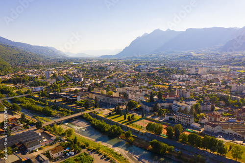 Scenic aerial view of French town of Albertville in green alpine valley on Arly River on sunny summer day © JackF