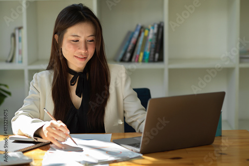 Businesswoman working on notebook laptop computer.