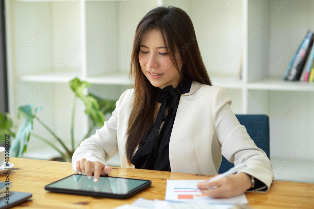 Financial broker analysing financial data and working on tablet. Financial broker analysing financial data and working on tablet.