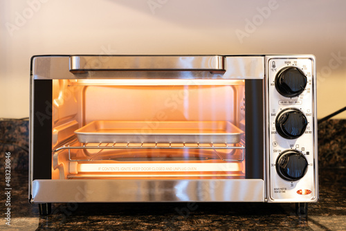 Fotografija Stainless steel modern design toaster oven is on the granite kitchen countertop