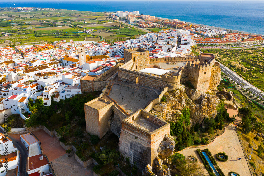 Picturesque view from drone of fortified castle in Spanish town of Salobrena with blue calm Mediterranean Sea on horizon..