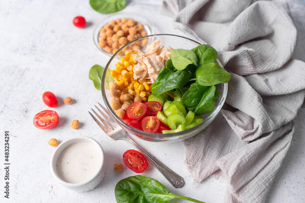 Salad bowl with chicken and protein. Healthy vegetable  buddha bowl with healthy greens. Fitness and weight loss food tomato, spinach and chickpeas salad. 