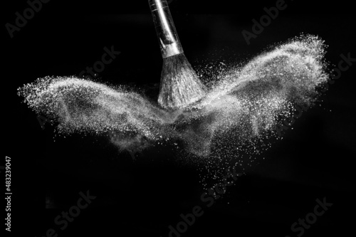 white powder explosion with black space with brush makeup