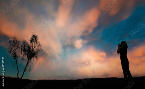 Fototapeta Naklejka Na Ścianę i Meble -  silhouette of a girl photographer on a sunset background
