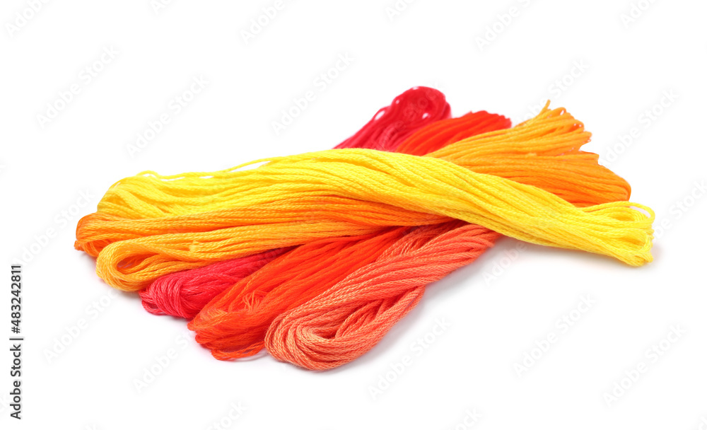 Different colorful embroidery threads on white background