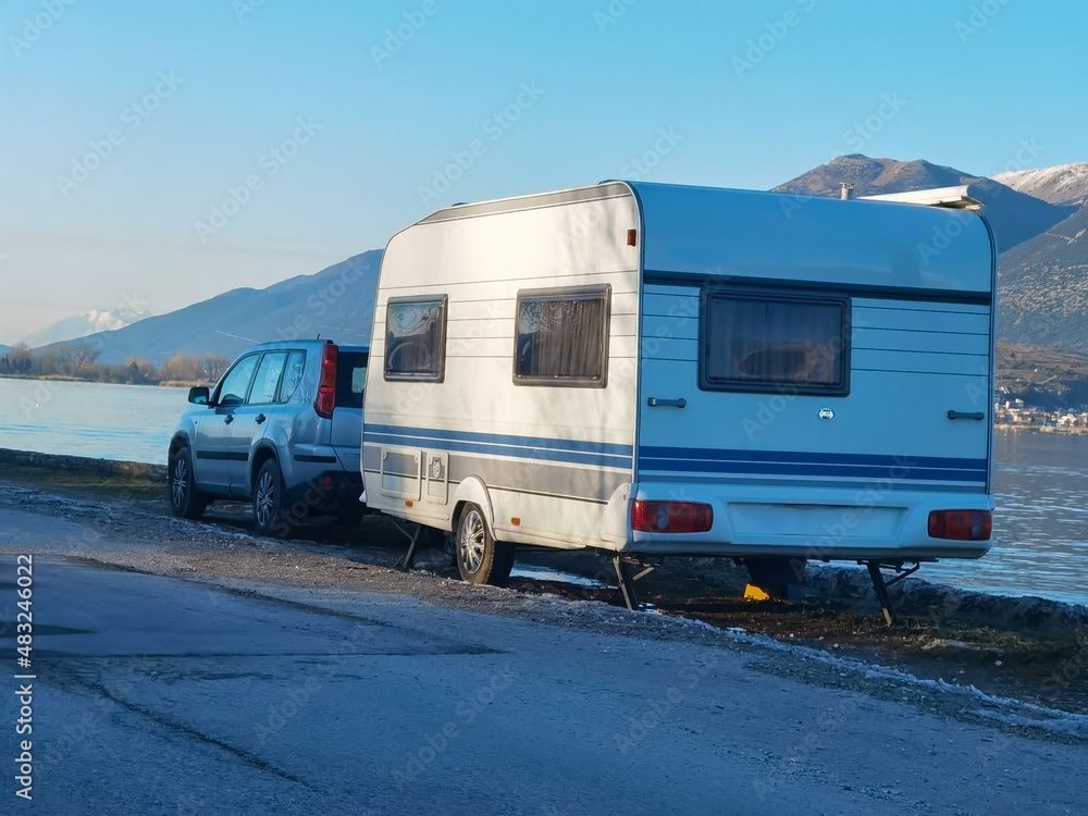 caravan trailer by the lake in winter season travelling