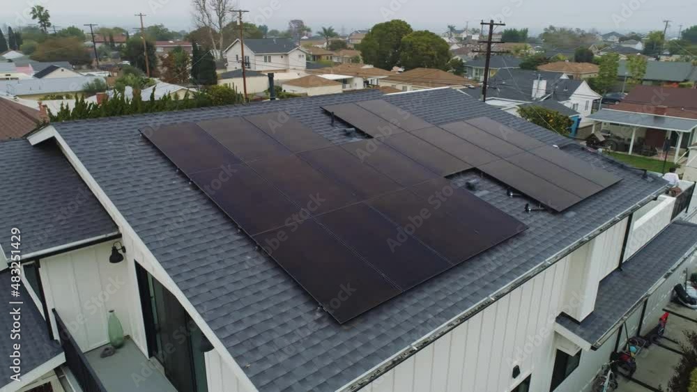 Aerial orbit around rooftop with solar panels installed on cloudy day Los Angeles, California