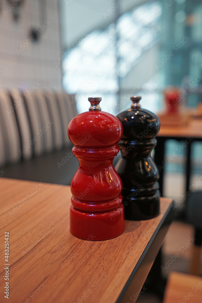 Close up Ceramic salt and pepper seasoning shaker on wooden table Close up Ceramic salt and pepper seasoning shaker on wooden table
