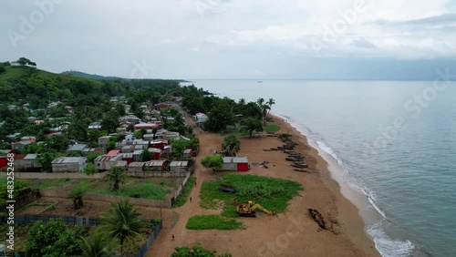 Aerial drone view over the Micolo beach and village, in cloudy Sao Tome, Africa