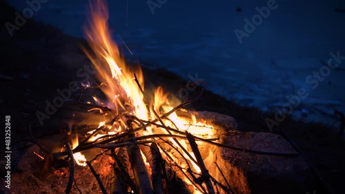 Beautiful Bonefire on the Bank of the River Lake at Sunset Dawn with Flames Detail and Beautiful Colors in UHD 4K