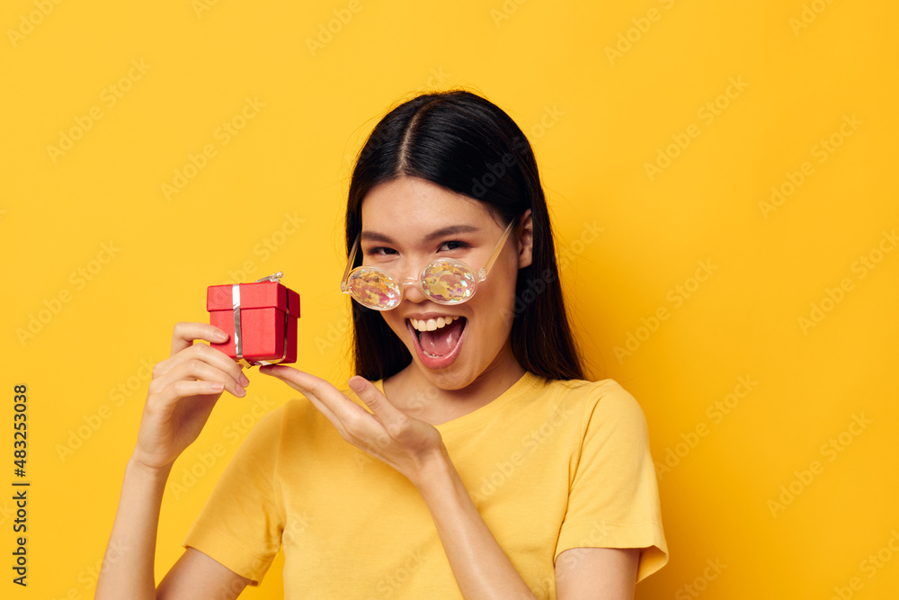 Charming young Asian woman wearing diamond glasses small gift box Lifestyle unaltered Charming young Asian woman wearing diamond glasses small gift box Lifestyle unaltered