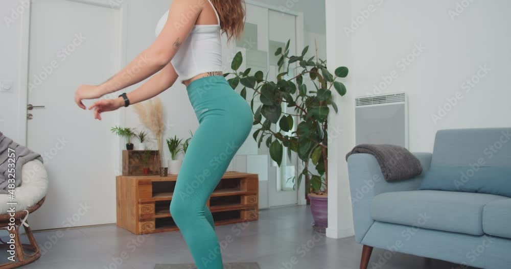 Slim Woman Performing Squat Exercise At Home. - wide shot Slim Woman Performing Squat Exercise At Home. - wide shot