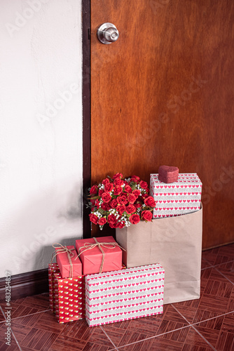 Paper art Valentine's day concept banner with hand made gift box. The concept of delivery of gifts and parcels for the holidays valentines day, pleasant surprises. box present and rose behind the door
