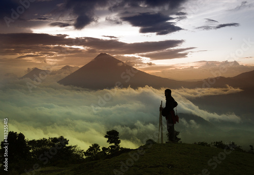 Sunset in the chain of volcanic mountains of the city of Antigua with a person in backlight photo