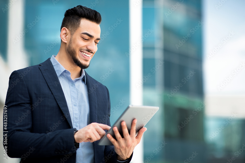 Successful arab guy in formal wear using digital tablet Successful arab guy in formal wear using digital tablet