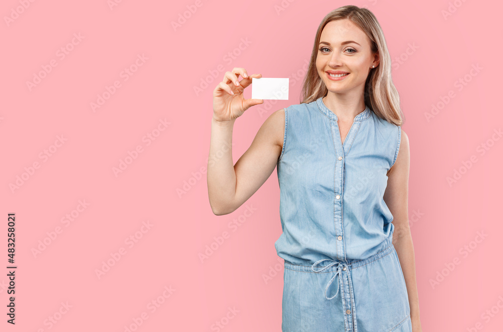 Happy beautiful casual woman holding a blank card isolated on color background Happy beautiful casual woman holding a blank card isolated on color background