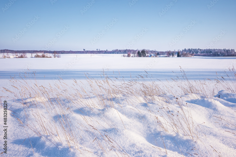 A beautiful winter day landscape of rural area. Snowy scenery of Northern Europe.